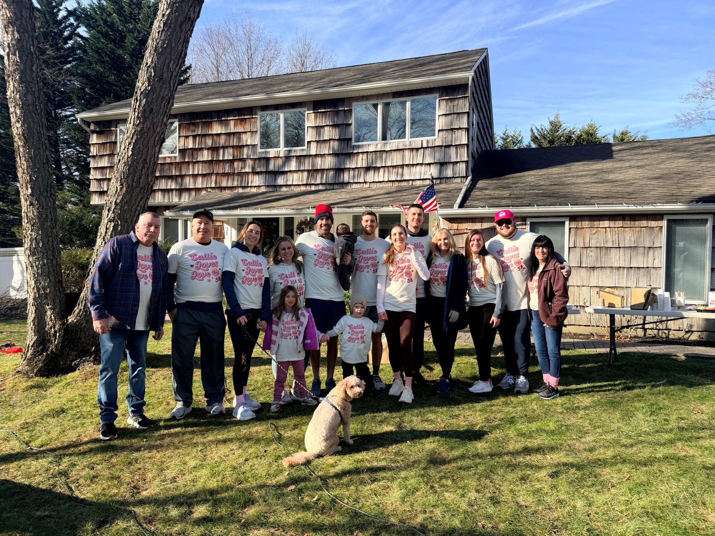 Family and friends in race shirts on the front lawn